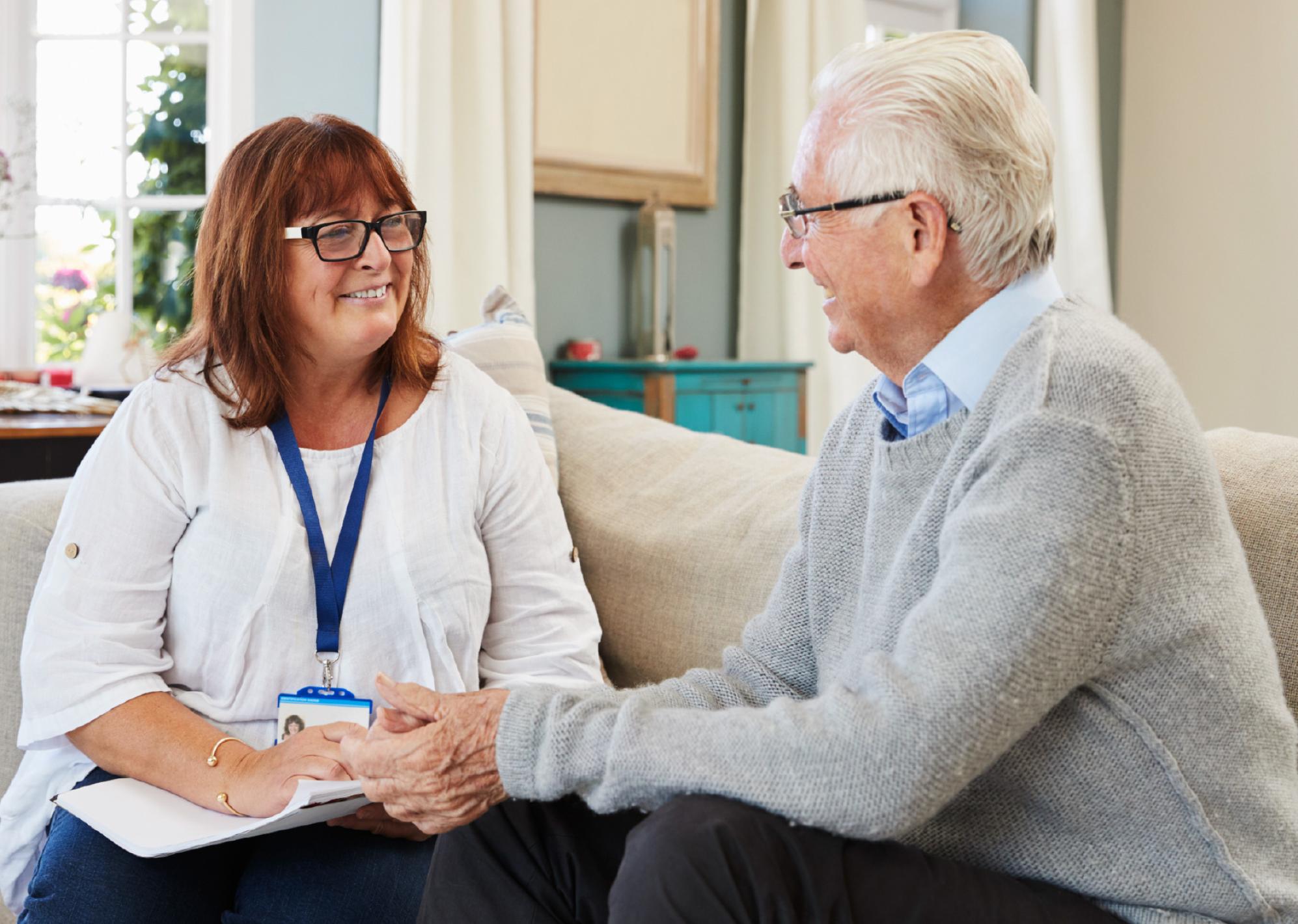woman speaking to an elderly man