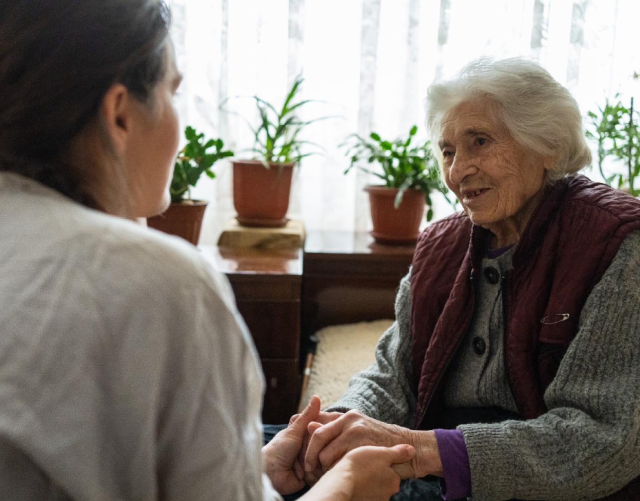 a woman holding hands with an elderly woman