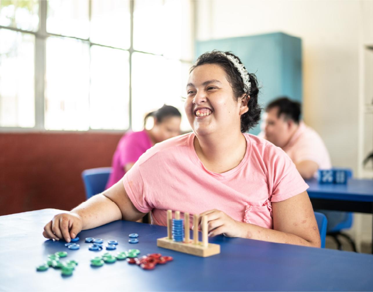 smiling girl playing with an abacus